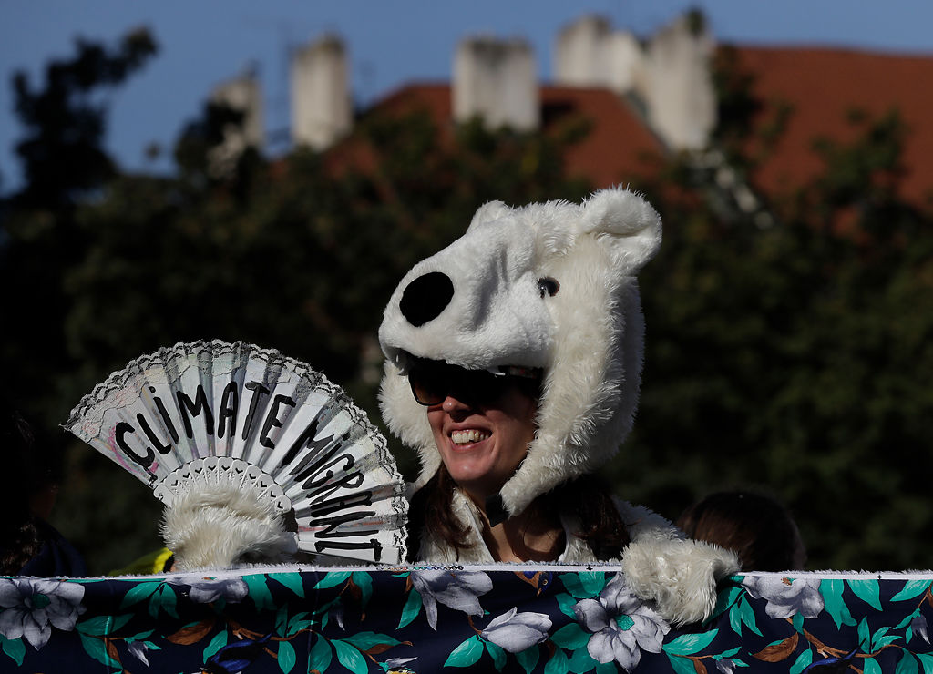 A girl wearing a polar bear costume joins a protest at the Old Town Square in Prague, Czech Republic
